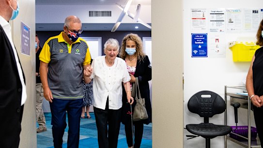 Prime Minister Scott Morrison accompanies Jane Malaysiak, the first person to get the coronavirus vaccine in Australia, to get her second dose.