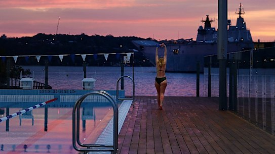 A swimmer stretches before her morning swim at the newly renovated Andrew (Boy) Charlton Pool, along the Mrs Macquarie’s Bushland Wal