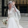 Kate Middleton in her Alexander McQueen wedding dress preparing to enter Westminster Abbey, with her sister Pippa carrying her train.