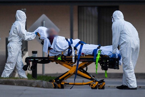 A St Basil’s resident is evacuated from the home in July 2020.