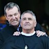 Neale Daniher pushes Chris Fagan down the slide.