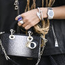 Right on time: A guest outside the Dior show in Paris brandishing her luxury watch in a sea of accessories.