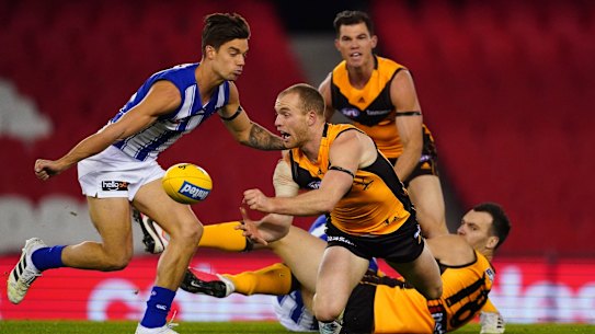 Too hot to handle: Hawk Tom Mitchell passes out under pressure as Jaeger O'Meara looks on.