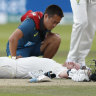 Steve Smith receives medical assistance after being hit in the neck by Jofra Archer. He left the field but returned to bat once Peter Siddle was dismissed. 