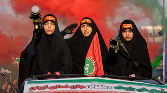 Women carrying weapons resembling shoulder-fired missiles ride in a truck during a pro-government National Army Day demonstration on April 17, 2026 in Tehran, Iran. 