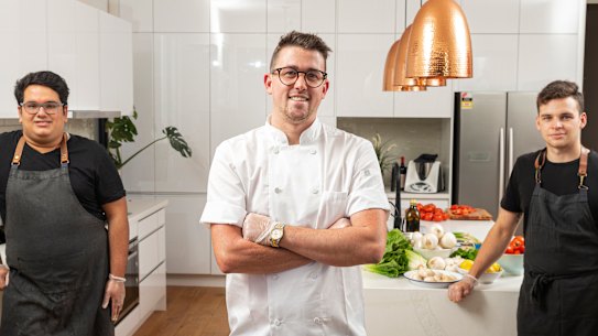 Helping hands: Charlie Carrington, centre, has retooled his business to ensure his foreign workers, including Parth Tuli, left, and Victor Blain, right, have ongoing income. 