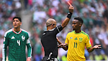 Referee Wilton Pereira Sampaio shows Themba Zwane (South Africa) a red card.