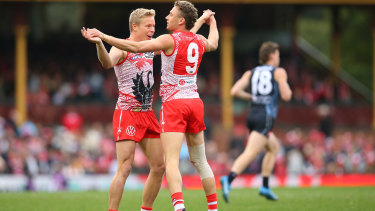 Will Hayward of the Swans  celebrates with Isaac Heeney.