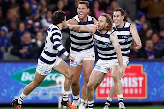 Tom Hawkins and the Cats celebrate a goal.