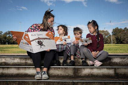 Teacher Simone Peachey, from Victoria Ave Public School, reads with kindergarten students 