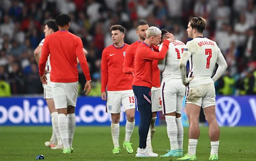 England’s Phil Foden consoles teammate Jadon Sancho after he misses the side’s fourth penalty
