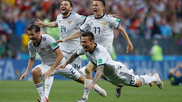 Unbelievable: Russia's Fyodor Smolov dives in celebration after their shootout triumph.