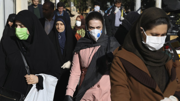 People wearing face masks in downtown Tehran on Monday.