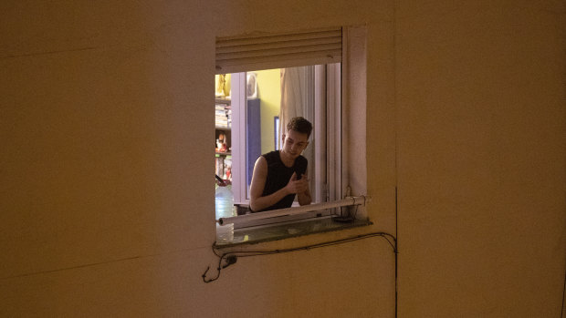 A man applauds from his window in support of the medical staff in Madrid, Spain. 