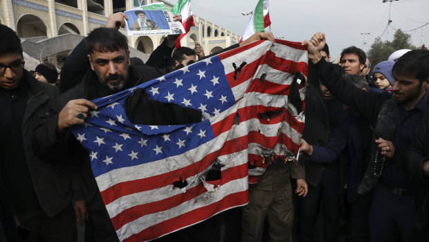 Protesters burn an American flag during a demonstration over the US killing of Qssem Soleimani in Tehran on Friday.