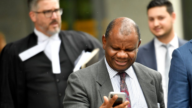 Dr Tony Mufutau Oluwatoyin Bakare (centre) has pleaded not guilty.