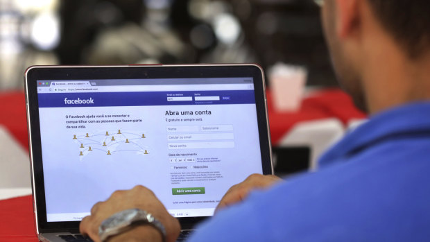 A man logs in to Facebook in Brasilia, Brazil.