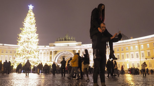A couple take a selfie photo at the Palace Square during New Year celebration in downtown St Petersburg, Russia.