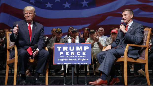 Then-presidential candidate Donald Trump gives a thumbs up as he speaks with Michael Flynn at a campaign event in 2016.