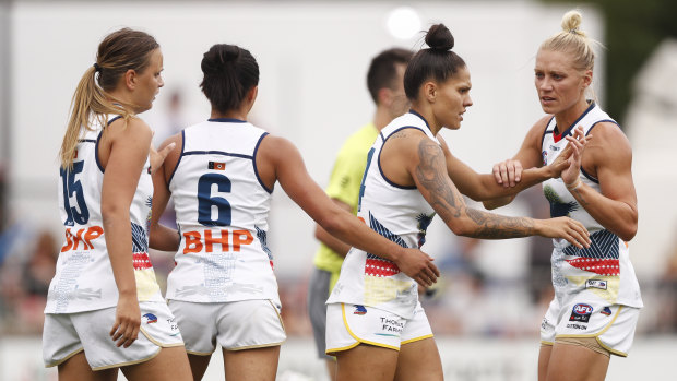 Hot shot: Stevie-Lee Thompson of the Crows (second right) celebrates a goal with Erin Phillips of the Crows (far right).