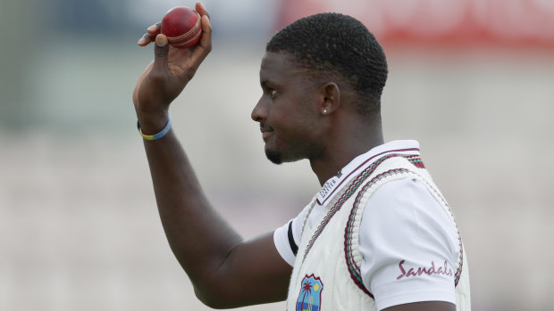 West Indies captain Jason Holder raises the ball after his sterling bowling performance, finishing with figures of 6-42.