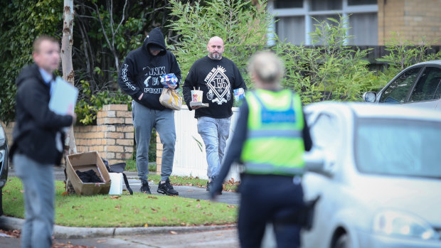 Men visit a property which was the target of a drive-by shooting in Frankston.