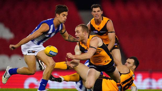 Too hot to handle: Hawk Tom Mitchell passes out under pressure as Jaeger O'Meara looks on.