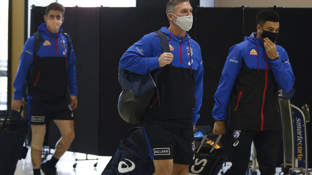 Tom Liberatore, Rohan Smith and Jason Johannisen at Melbourne Airport on Sunday.