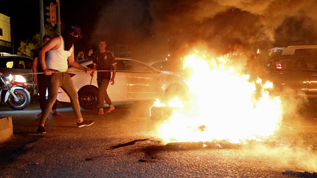 Iraqi protesters demanding services and jobs burn tyres during a demonstration in Basra, 550 kilometres  south-east of Baghdad. 