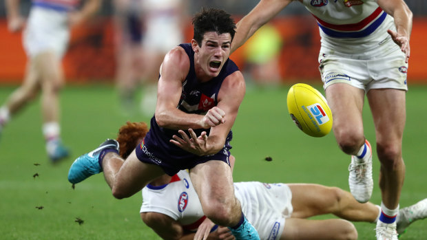 Docked: Fremantle's Andrew Brayshaw gets a hand pass away under pressure.
