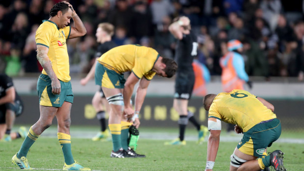 Spent: Wallabies players after full-time of Saturday's match against New Zealand at Eden Park. 