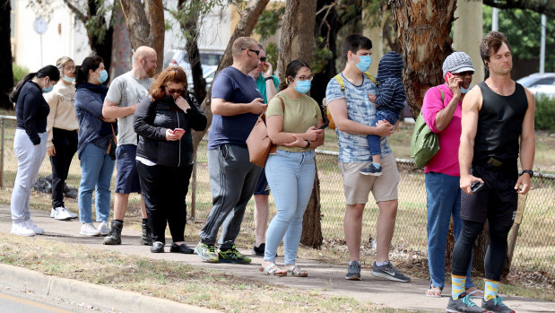 People queuing at a COVID-19 testing site at Parafield Airport in Adelaide on Monday.