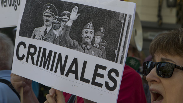 A protester holds a banner with a photo of Spanish dictator General Francisco Franco, right, with Adolf Hitler during a protest in Madrid, Spain, last month.