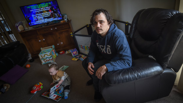 Temporary worker Sam Melville, with  10-month-old son Ragnarok, is facing financial strife after he lost his job last week.