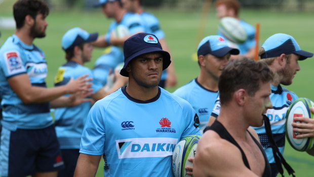 Colourful past: Karmichael Hunt (centre, dark blue hat) trains with the Waratahs during the week.