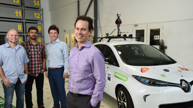 QUT Professor Michael Milford (front) and his team with the test vehicle that is trialling autonomous vehicle sensors and cameras.