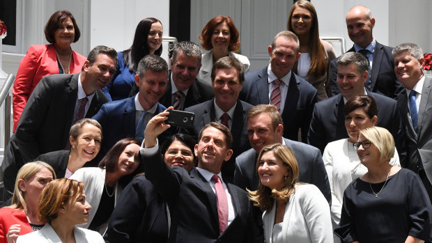 Former state development minister Cameron Dick (centre) takes a selfie with his fellow ministers after a swearing in ceremony in 2017.