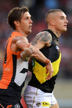 Matt de Boer (left) puts the clamps on Dustin Martin earlier this year.