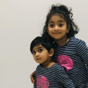 Tharunicaa, left, is pictured with her three-year-old sister Kopika in May.