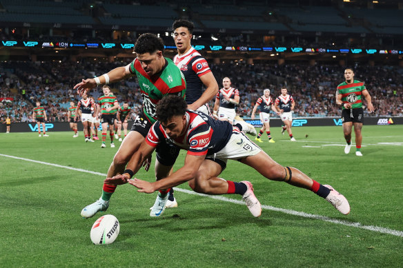 Junior Pauga wins the race to a James Tedesco kick to score his third try.