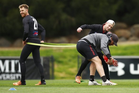 Ben Rutten is tackled by Nick Hind at Essendon training on Thursday.