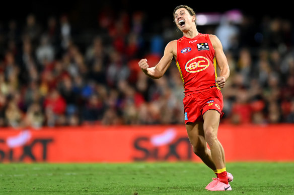 Thomas Berry kicks a goal that helps Gold Coast to defend its unbeaten record at home.