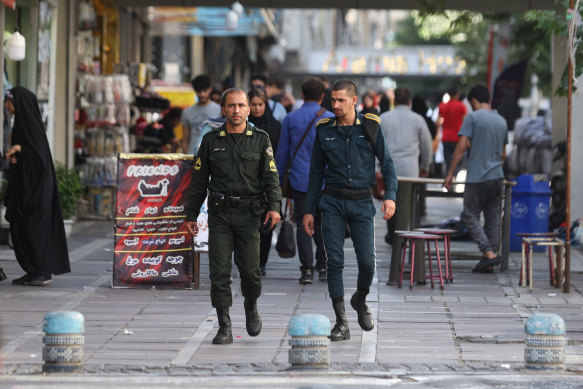 Iran’s police forces walk along a street during the revival of morality police in Tehran on Sunday. 