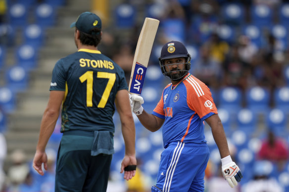 Indian captain Rohit Sharma celebrates scoring his half-century against Australia.