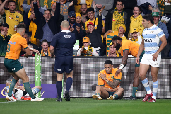 Len Ikitau holds his shoulder after scoring a try against Argentina at CommBank Stadium in July that ultimately cost him selection for the Wallabies in France.