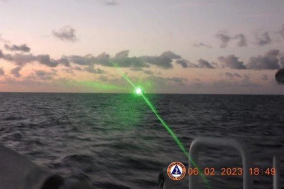 A green light appears from the direction of a Chinese coast guard ship at the Second Thomas Shoal, 105 nautical miles off the Palawan Province, Philippines, February 6, 2023 in this handout image.