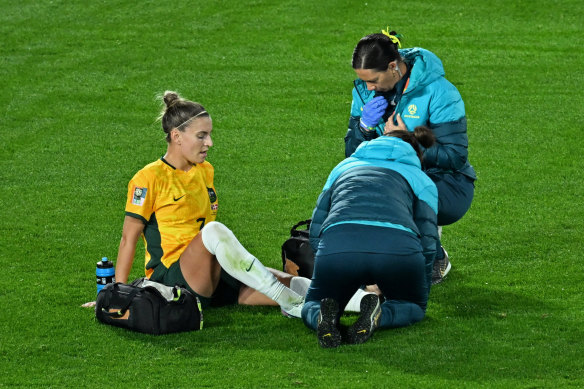 Steph Catley receives medical attention after going down midway through the first half against Denmark.