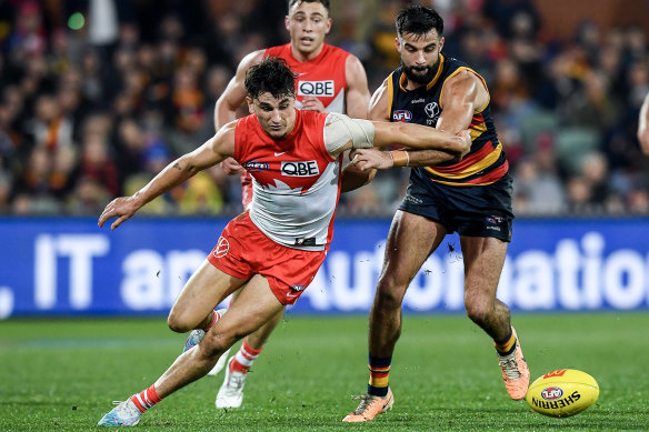Sam Wicks of the Swans competes with Wayne Milera of the Crows.