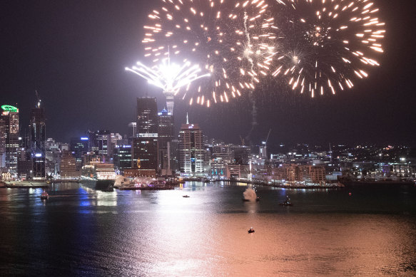 Fireworks are seen exploding from Auckland's Waitemata Harbour and Sky Tower.