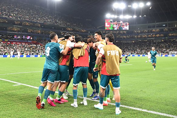 Iraq players celebrate their second goal.